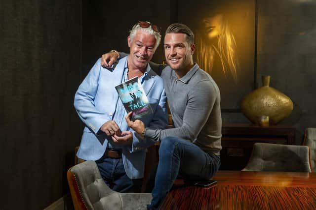 Daz Courtney with son Tom Zanetti pictured with the book at Dakota Hotel, Leeds.