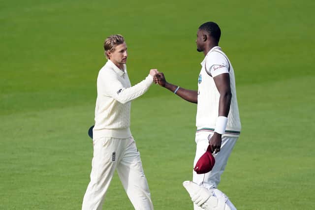 England's Joe Root (left) and West Indies' Jason Holder fist bump after the match at Emirates Old Trafford. Picture: Jon Super/NMC Pool/PA