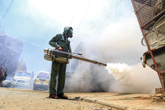 A government worker that is part of a combined taskforce tackling COVID-19 coronavirus fumigates a neighbourhood as part of safety precautions, in Yemen's capital Sanaa.