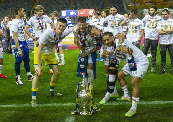 Leeds United players 
Illan Meslier, Ben White Kalvin Phillips and Tyler Roberts celebrate with the Sky Bet Championship trophy at Elland Road on Wednesday. Picture: Tony Johnson.