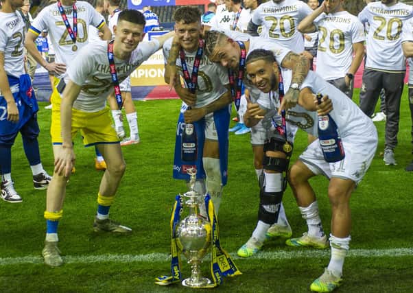 Leeds United players Illan Meslier, Ben White, Kalvin Phillips and Tyler Roberts pose with the Championship trophy. Picture: Tony Johnson/JPIMedia.