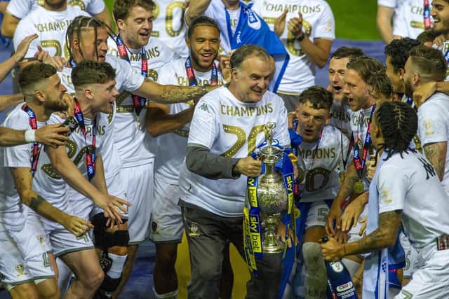JOB DONE: As far as the Championship is concerned as Leeds United head coach Marcelo Bielsa lifts the Championship winners' trophy surrounded by his players after Wednesday's 4-0 hammering of Charlton Athletic. Picture by Tony Johnson.