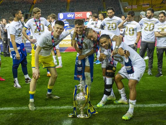 Leeds United's Tyler Roberts (R) celebrates with the Championship trophy alongside Kalvin Phillips, Ben White and Illan Meslier. (Tony Johnson)