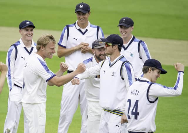 Well done: Yorkshire's Matthew Waite is congratulated on dismissing Lancashire's Rob Jones. Pictures: SWPix