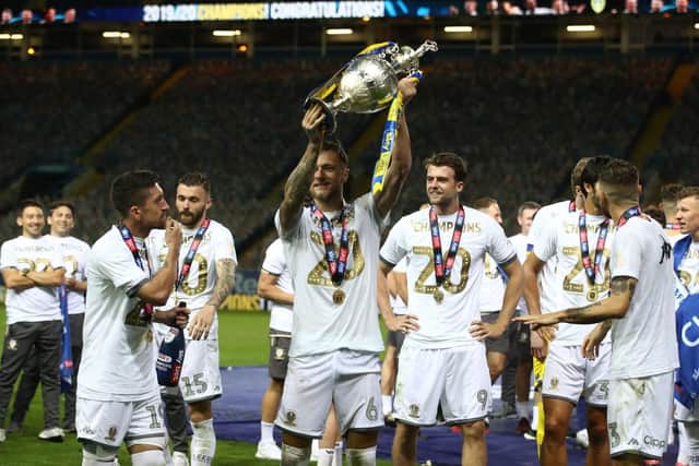 Leeds United captain Liam Cooper lifts the Championship trophy at Elland Road. (PA)