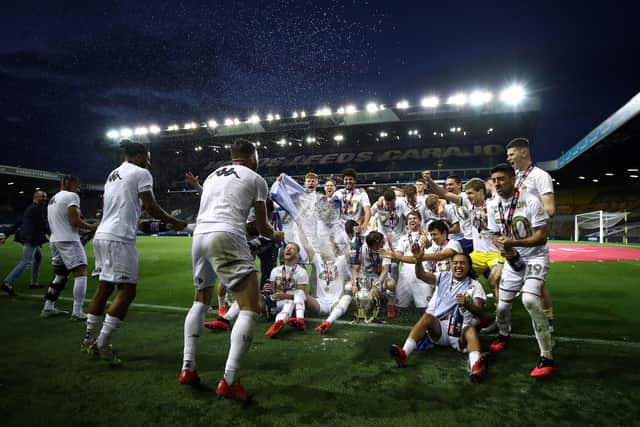 Leeds United players celebrate lifting the Championship trophy at Elland Road. (PA)