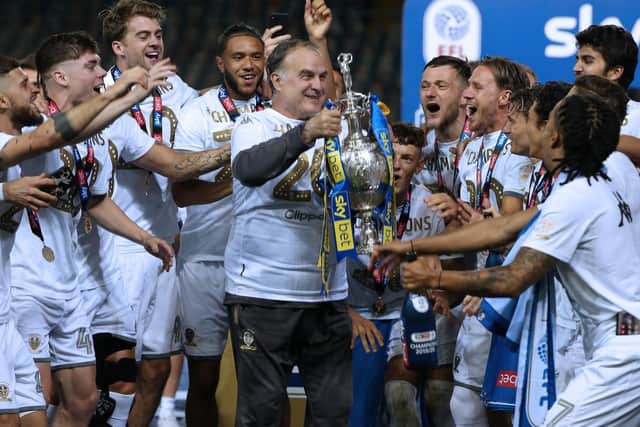 Marcelo Bielsa lifting the Championship trophy for Leeds United after the manager took the club back to the Premier League. Picture: Andrew Varley.