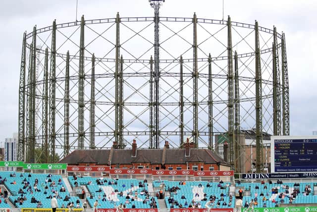 Fans are seen sitting apart in the stands as play begins during the friendly match between Surrey and Middlesex at the Kia Oval - the first time fans have attended a live sports event in England since the coronavirus lockdown began in March. Picture: Adam Davy/PA