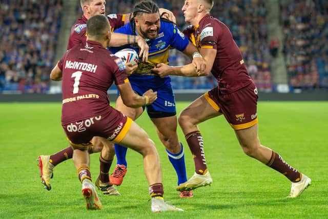 Alex Mellor, right, moves in to collar Rhinos' Konrad Hurrell during Leeds' win over Huddersfield on August 2 last year. Picture by Bruce Rollinson.