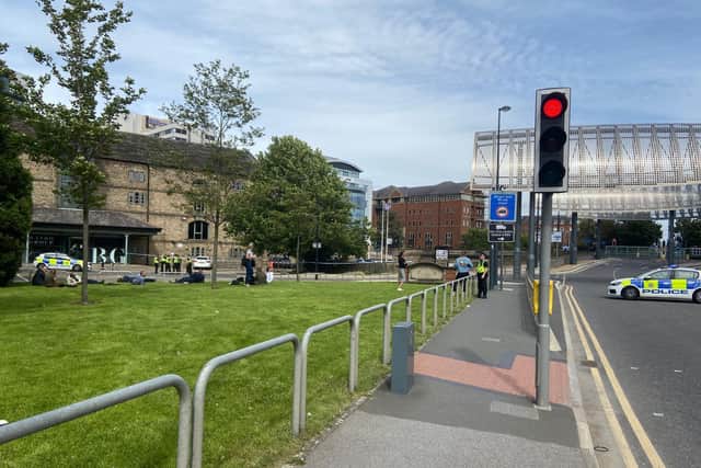 The scene after a 'rusty metal object' was pulled out of the river at Canal Wharf