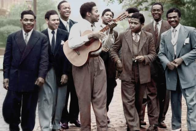 Early members of the Caribbean Cricket Club formed by Jamaican ex RAF servicemen in 1948, gather in Hyde Park, Leeds, en route to a cricket match circa 1953. Back row (LR): Vince Stewart, Errol James, Bill Campbell, Warren Lawson. Middle row: Mr Morant (partly hidden), Mac McCarthy, Astley Thomas. Front : Unidentified man, Alford Gardner on guitar.
Original black and white photo: Yorkshire Evening News