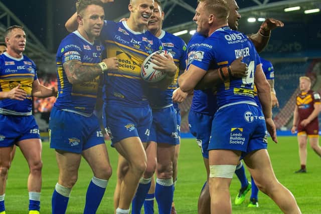 Rhinos celebrate after a try by Ash Handley, with ball, in last year's win at Huddersfield. Picture by Bruce Rollinson.