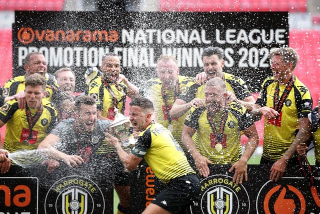 Harrogate Town's Josh Falkingham lifts the trophy with his team-mates after winning the National League play-off final at Wembley Stadium. Picture: Adam Davy/PA