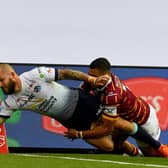 02 August 2020. Picture James Hardisty.Huddersfield Giants v Leeds Rhino's, in the Betfred Super League match held at Emerald Headingley Stadium, Leeds. Pictured Luke Briscoe, of Leeds Rhinos, dives to score a try whilst been tackled by Darnell Mcintosh, of Huddersfield Giants.