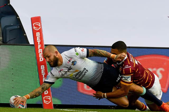 02 August 2020. Picture James Hardisty.Huddersfield Giants v Leeds Rhino's, in the Betfred Super League match held at Emerald Headingley Stadium, Leeds. Pictured Luke Briscoe, of Leeds Rhinos, dives to score a try whilst been tackled by Darnell Mcintosh, of Huddersfield Giants.