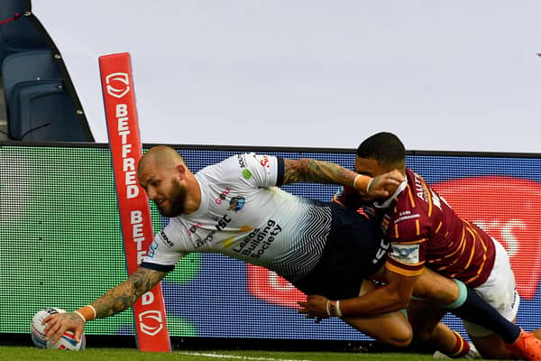 02 August 2020. Picture James Hardisty.Huddersfield Giants v Leeds Rhino's, in the Betfred Super League match held at Emerald Headingley Stadium, Leeds. Pictured Luke Briscoe, of Leeds Rhinos, dives to score a try whilst been tackled by Darnell Mcintosh, of Huddersfield Giants.
