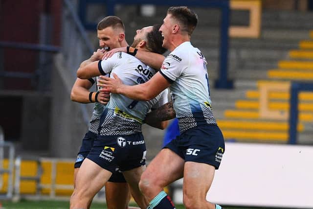 02 August 2020. Picture James Hardisty.Huddersfield Giants v Leeds Rhino's, in the Betfred Super League match held at Emerald Headingley Stadium, Leeds. Pictured Luke Gale, of Leeds Rhinos, celebrates with his teammates after his drop kick wins the match for Leeds Rhino's.