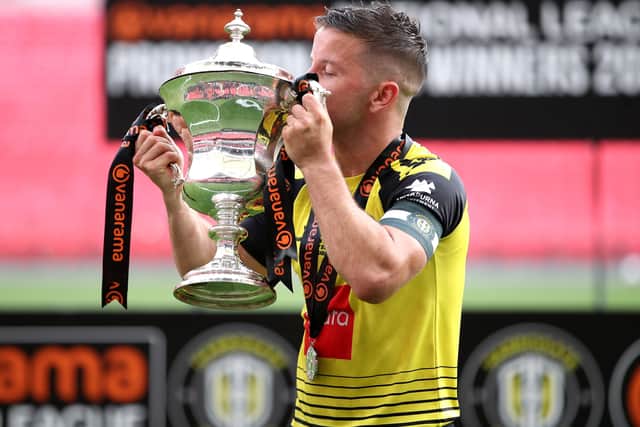Harrogate Town's Josh Falkingham with the play-off final trophy at Wembley Stadium on Sunday. Picture: Adam Davy/PA