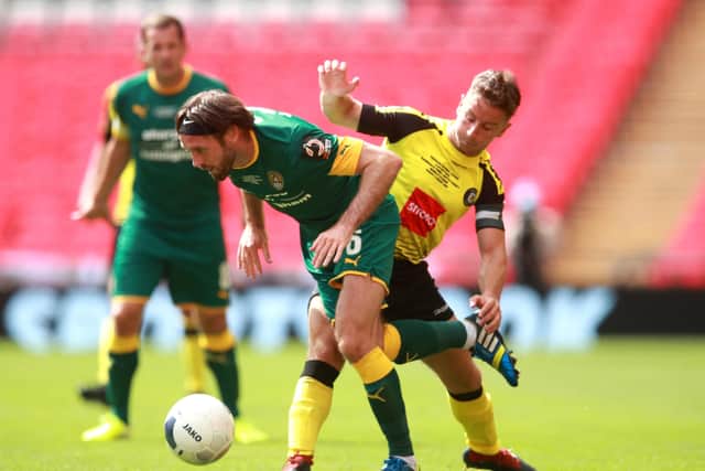 Notts County's Jim O'Brien (left) and Harrogate Town's Josh Falkingham battle for the ball during the Vanarama National League play-off final at Wembley Stadium. Picture: Adam Davy/PA