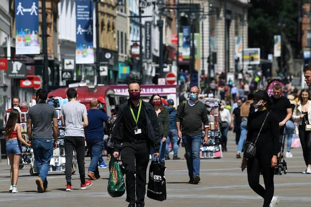 Shoppers wear face masks on Briggate, in Leeds.