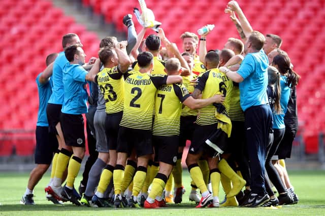 Harrogate Town players and staff celebrate after the final whistle at Wembley. Picture: Adam Davy/PA