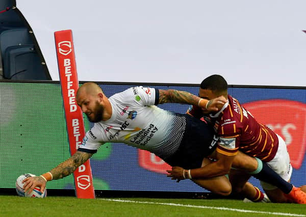 02 August 2020. Picture James Hardisty.
Huddersfield Giants v Leeds Rhino's, in the Betfred Super League match held at Emerald Headingley Stadium, Leeds. Pictured Luke Briscoe, of Leeds Rhinos, dives to score a try whilst been tackled by Darnell Mcintosh, of Huddersfield Giants.