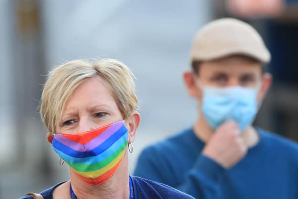 A woman wearing a face mask walks through the centre of Bradford, West Yorkshire, one of the areas where new measures have been implemented to prevent the spread of coronavirus. Stricter rules have been introduced for people in Greater Manchester, parts of East Lancashire, and West Yorkshire, banning members of different households from meeting each other indoors. Photo: PA