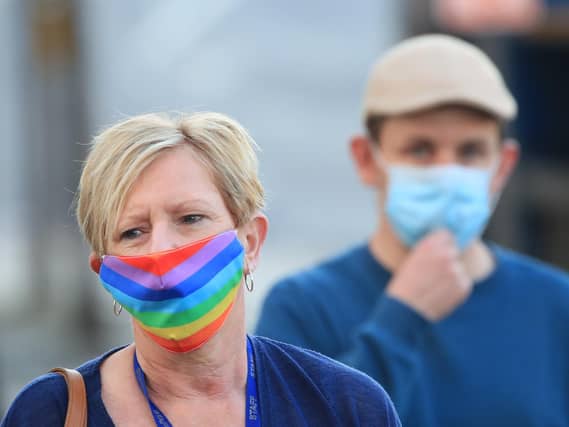 A woman wearing a face mask walks through the centre of Bradford, West Yorkshire, one of the areas where new measures have been implemented to prevent the spread of coronavirus. Stricter rules have been introduced for people in Greater Manchester, parts of East Lancashire, and West Yorkshire, banning members of different households from meeting each other indoors. Photo: PA