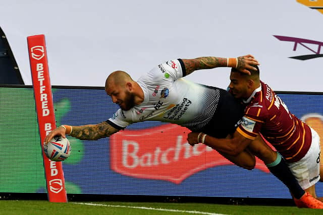 Luke Briscoe dives to score against Huddersfield Giants on Sunday. Picture: James Hardisty.