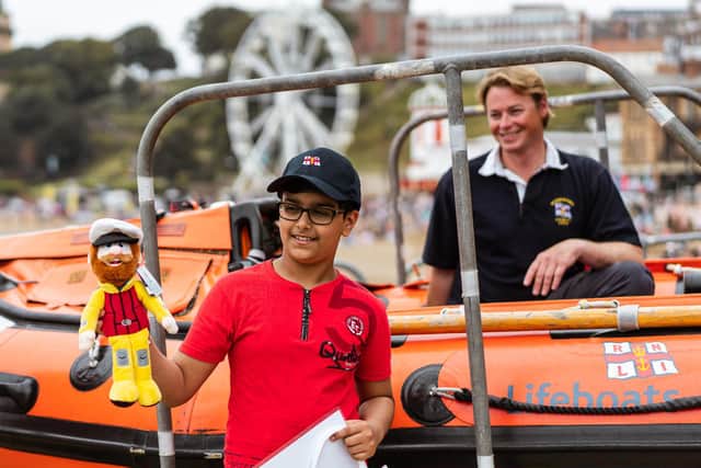 Ravi Saini, 10, from Leeds, during a visit to Scarborough lifeboat station to thank them after they rescued him