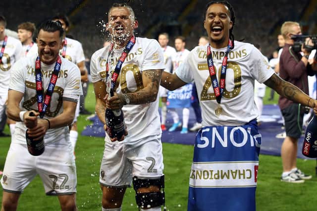 CHEERS TO THAT: Jack Harrison, left, celebrates Leeds United's promotion to the Premier League as Championship champions with Kalvin Phillips, centre, and Helder Costa. Picture by Tim Goode/PA Wire.