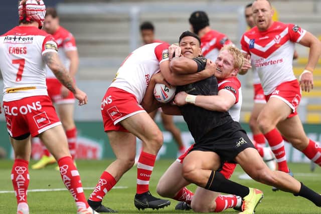 Israel Folau is tackled by St Helens' James Bentley and James Graham at Headingley last weekend. Picture by Martin Rickett PA Wire