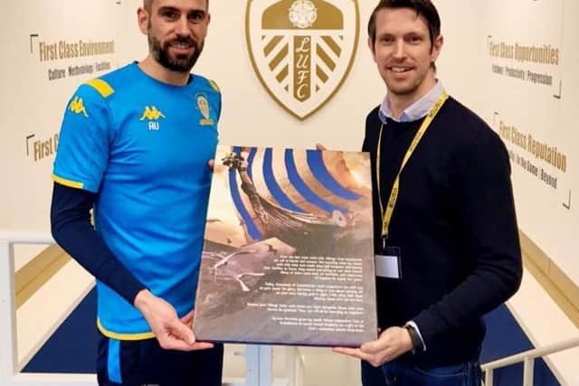 Svend Karlsen presents academy manager Adam Underwood with an illustration describing the connection between the club and Nordic fans.