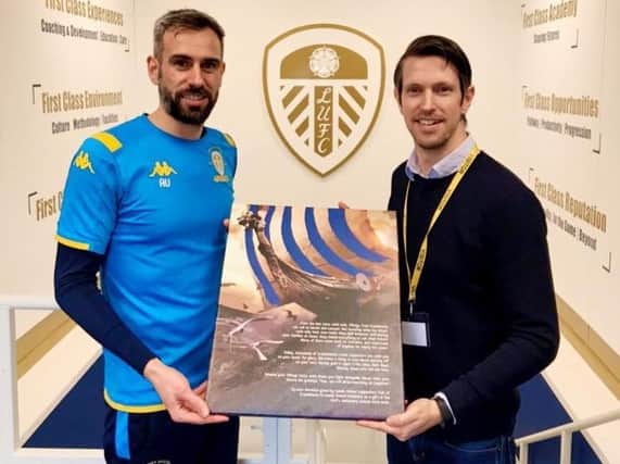 Svend Karlsen presents academy manager Adam Underwood with an illustration describing the connection between the club and Nordic fans.