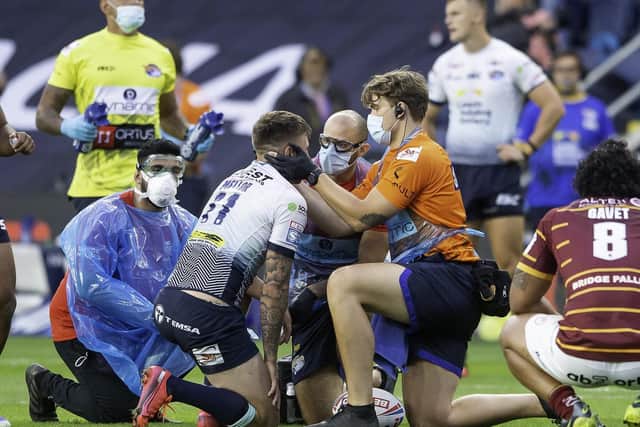 Leeds Rhinos player Alex Mellor is examined after an injury by the physio staff in masks during the Leeds Rhinos v Huddersfiel;d Giants clash at Emerald Headingley Stadium on August 2.

Picture by Allan McKenzie/SWpix.com -