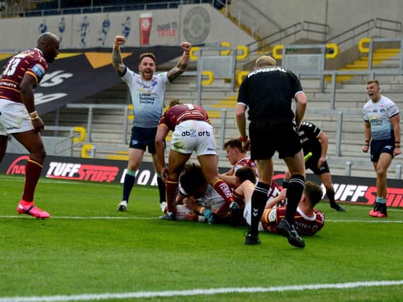 Richie Myler and Ash Handley celebrate Konrad Hurrell's game-saving try against Huddersfield. Picture by James Hardisty.
