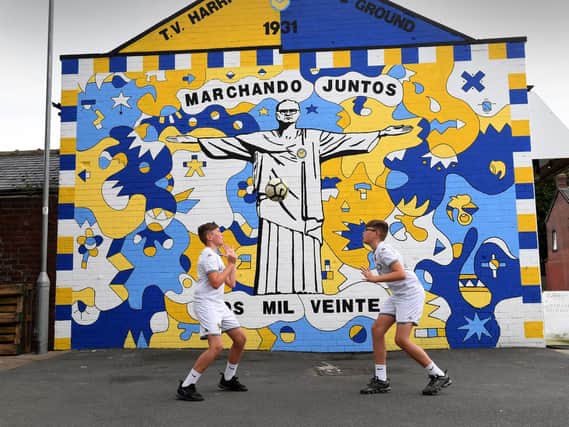 Identical twins Kailen Hatfield (right) and his brother Mason Hatfield. aged 12, pictured by the new mural unveiled in Leeds dedicated to Marcelo Bielsa.