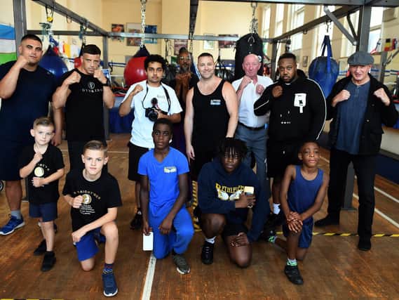 Lee Murtagh(centre) at the Bethlehem Boxing Club in Leeds with some of the people that took part in bhis film 'Staight'ner' including Brfitish Commonwealth and European Champion Crawford Ashley (back centre) and Steve Ward, 63,  the oldest pro boxer in the world (right wearing cap).