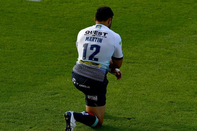 Rhyse Martin takes a knee in support of Black Lives Matter before last week's game. Picture by James Hardisty.