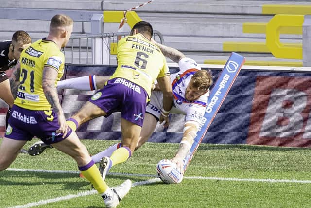 Somehow Tom Johnstone squeezes in at the corner for Wakefield against Wigan. Picture: Allan McKenzie/SWpix.com.