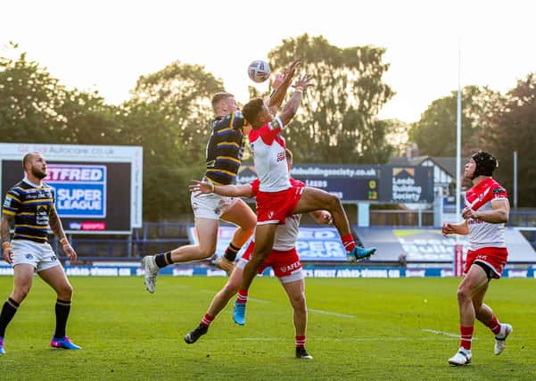 Picture by Alex Whitehead/SWpix.com - 09/08/2020 - Rugby League - Betfred Super League - Leeds Rhinos v St Helens - Emerald Headingley Stadium, Leeds, England - St Helens' Regan Grace and Leeds' Harry Newman challenge for the ball in the air.