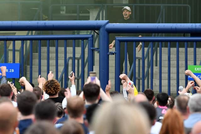 WE MISS YOU: Kalvin Phillips celebrates in front of Leeds United's fans after the Whites' promotion to the Premier League was confirmed following Huddersfield Town's defeat of West Brom. Photo by PAUL ELLIS/AFP via Getty Images.