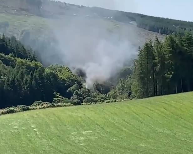 A screen grab from BBC Scotland showing smoke billowing from the train on the track in the countryside near Stonehaven, Aberdeenshire.