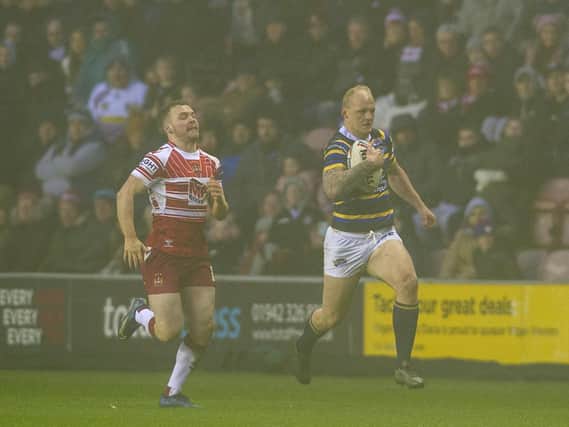Rhys Evans races through the fog in a pre-season game at Sunday's opponents Wigan Warriors. Picture by Tony Johnson.