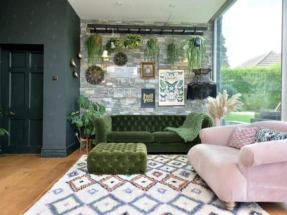 The sitting area in the open plan living kitchen with sofa by Rose & Grey and a suspended ladder to hang plants from