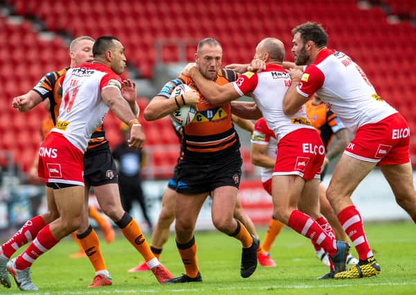 Liam Watts is held by James Roby during the weekend's encounter against St Helens. Picture: Bruce Rollinson/JPIMedia.