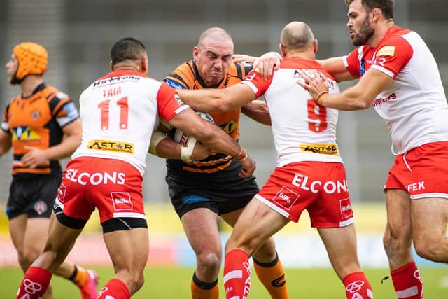 Grand Millington is tackled by Saints' James Roby, Zeb Taia and Alex Walmsley. Picture by Isabel Pearce/SWpix.com.