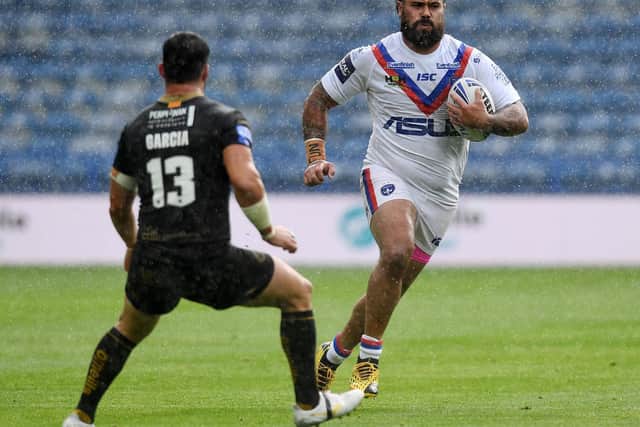 Trinity's David Fifita takes on Ben Garcia of Catalans in torrential rain during the Challenge Cup sixth round tie.