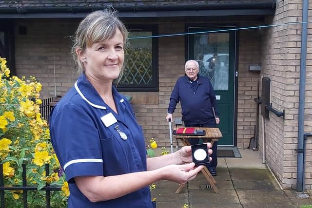 Therese Dales, associate community matron at Leeds Community Healthcare NHS Trust is pictured with one of the medals, as William Wheatley looks on.