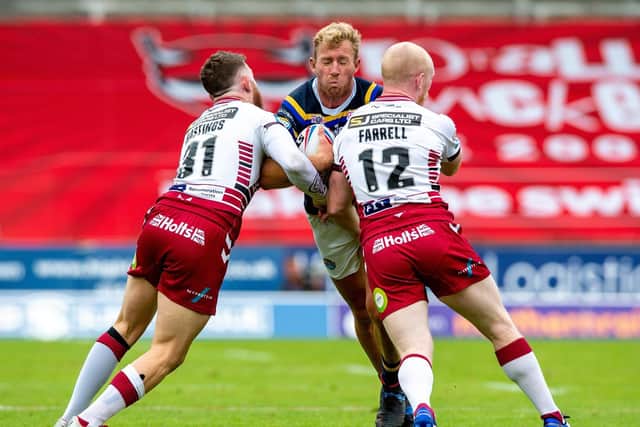 Jackson Hastings and Liam Farrell team up to halt Rhinos' Matt Prior in the game on August 16.